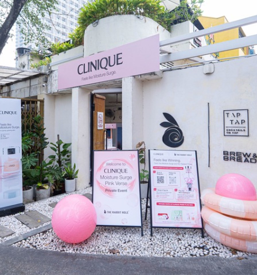 The Clinique Moisture Surge Pink-Verse takeover entrance at The Rabbit Hole cafe, with pink signage and props