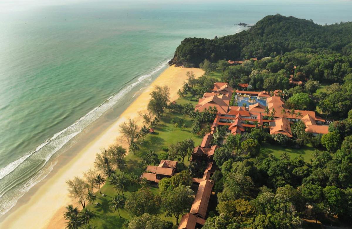 Aerial view of Club Med Cherating, with terracotta-roofed chalets set between an 80-hectare jungle and a long sandy beach on the Pahang coast