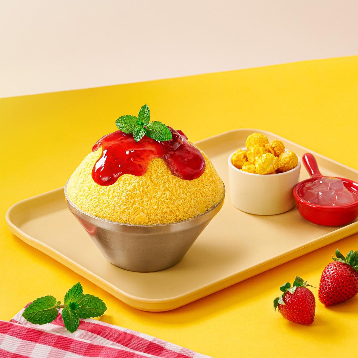 K Fry Poppin' Sweet Corn Bingsoo, a mound of shaved ice topped with strawberry jam, mint and caramel popcorn on the side