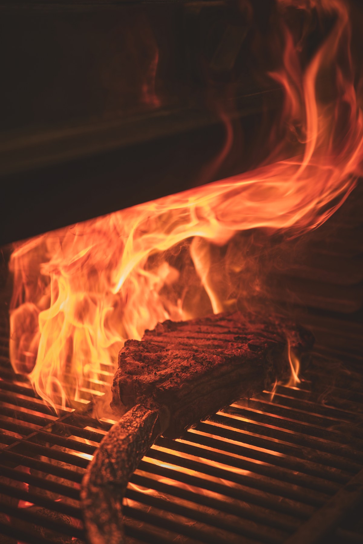 A steak searing over open flames on the Mi Brasa grill at Sabato's, Kimpton Naluria Kuala Lumpur, during its week-long Chop House.