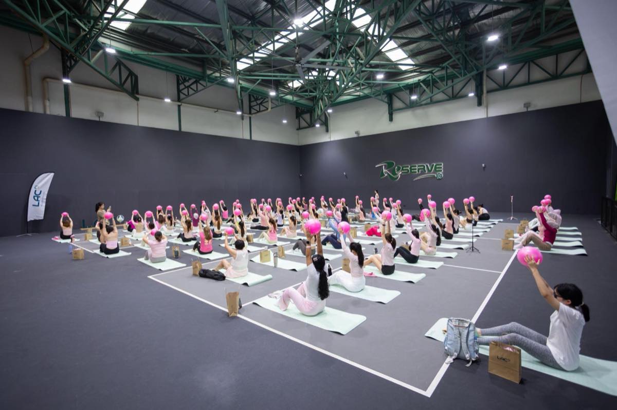 Women taking part in a Pink-Lates Pilates session with pink exercise balls at the LAC Community Pink October morning