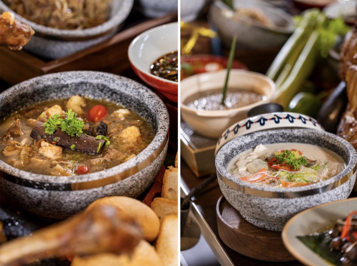 Stone bowls of Malaysian soups and curries from the M Social Resort Penang Taste of Malaysia buffet, garnished with herbs and chilli