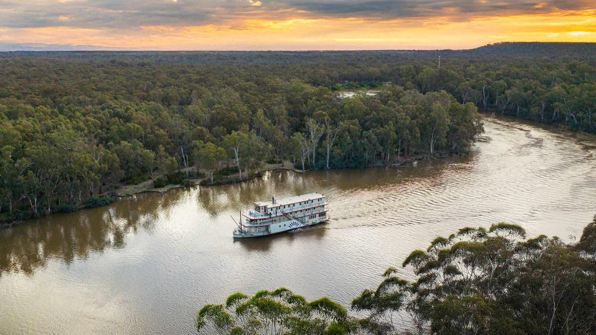 The PS Australian Star paddlesteamer cruising the Murray River at sunset