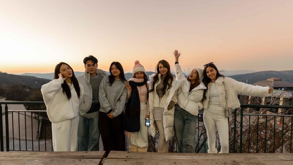 A group of Malaysian creators watching the winter sunset over the hills of regional Victoria