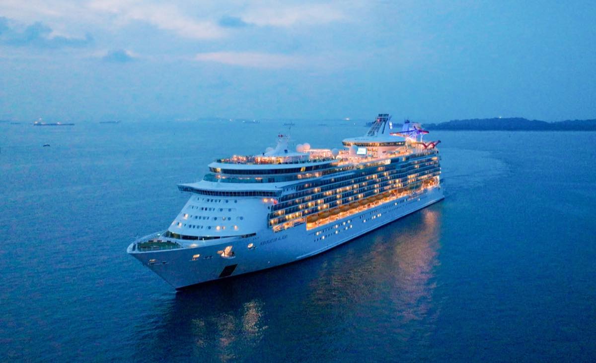 Navigator of the Seas lit up at dusk off the Singapore coast