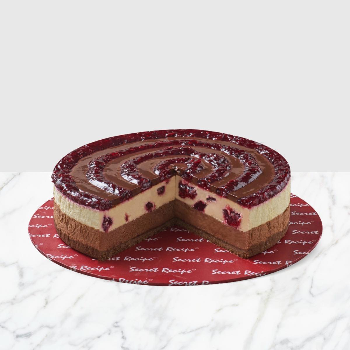 A layered Secret Recipe chocolate and berry cheese cake on a Secret Recipe board