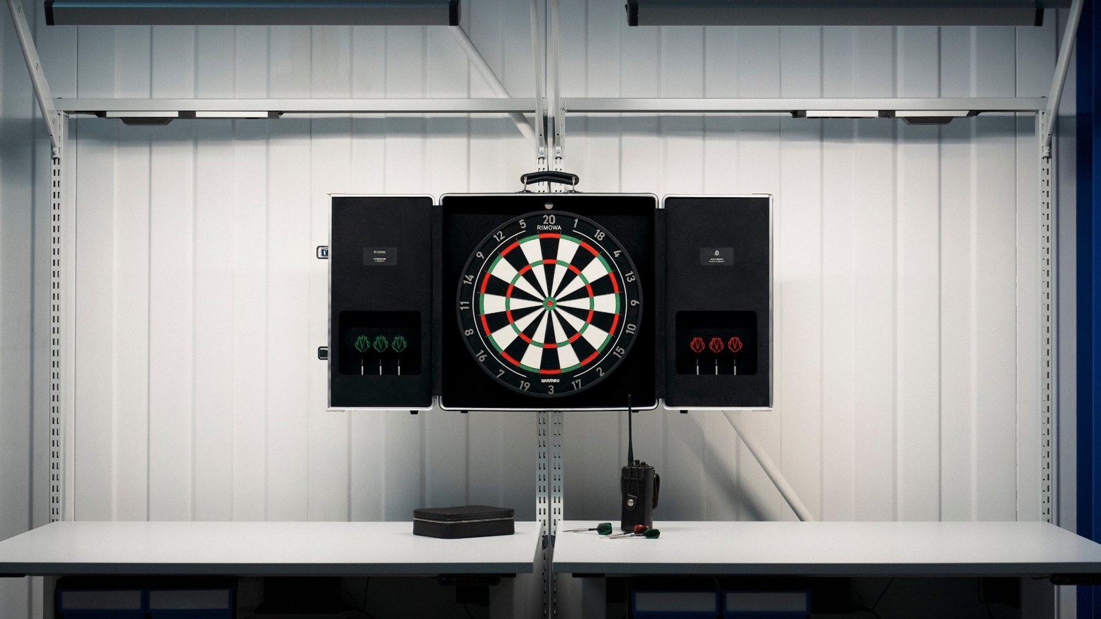 The RIMOWA Dartboard Case opened to reveal the Winmau Blade X dartboard and two dart sets