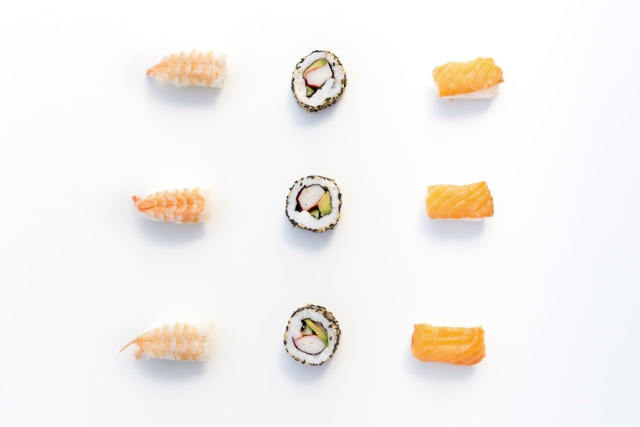 An assortment of sushi showing a wide variety of pieces