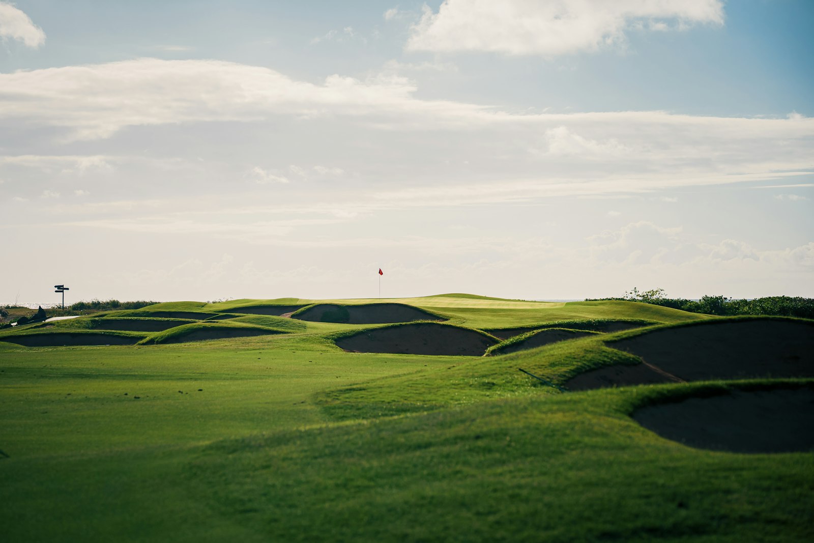 Golf course fairway and bunkers; the WAGC World Final 2026 plays The Els Club Desaru Coast